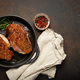 Two roasted duck breast fillets with crispy skin, with pepper and rosemary, top view in black cast - PhotoDune Item for Sale