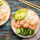 Two white ceramic bowls with rice, shrimps, avocado, vegetables and sesame seeds and chopsticks on - PhotoDune Item for Sale