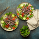 Two plates with traditional Thai beef salad with vegetables and mint top view served on rustic - PhotoDune Item for Sale