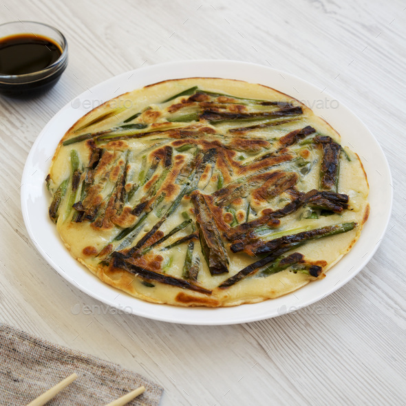 Homemade korean Pajeon scallion pancake on a white plate on a white ...