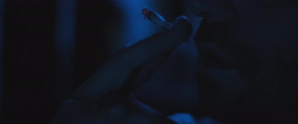 Close up of a man smoking a cigarette outside at night, dealing with anxiety and post trauma alt