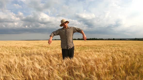 Young Agronomist Standing at Ripe Barley Meadow and Looking Like a Scarecrow alt