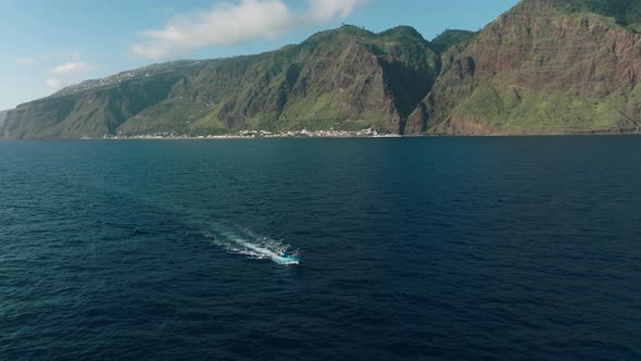 Local fishing boat from Paul do Mar out to go fishing, Madeira; aerial alt