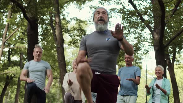 Trainer Having Workout with Group of Seniors Outdoors alt