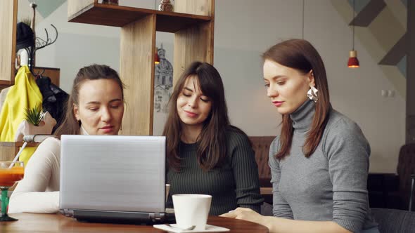 Successful Women Team in Coworking Center Reading a Message with Good News in Laptop an Then Giving alt