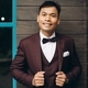 Wedding day. Asian groom poses on the background of a wooden building and large windows. - PhotoDune Item for Sale