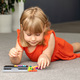 A focused girl is engaged in a colorful logic game. Games for children&#39;s development - PhotoDune Item for Sale