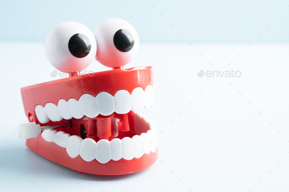 Tooth funny toy denture red color jaw and eye. Stock Photo by chormail