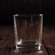 Closeup Ice Cubes Fall Into an Empty Glass on a Dark Wooden Background - VideoHive Item for Sale