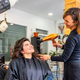 Complicity between hairdresser and customer while drying the hair - PhotoDune Item for Sale