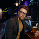 Pensive of relaxed businessman with glass of foamy beer in bar - PhotoDune Item for Sale
