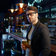 Portrait of relaxed businessman with glass of foamy beer in bar - PhotoDune Item for Sale