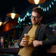 Relaxed businessman with glass of foamy beer in bar - PhotoDune Item for Sale