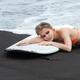Surfer woman lying on surfboard, eyes closed, feeling warmth of sun on skin and gentle sway of ocean - PhotoDune Item for Sale