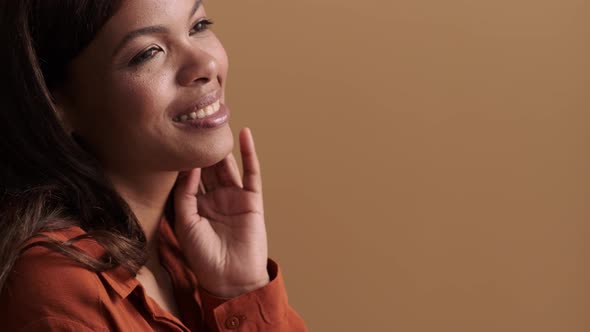A close-up view of a happy african american woman posing alt