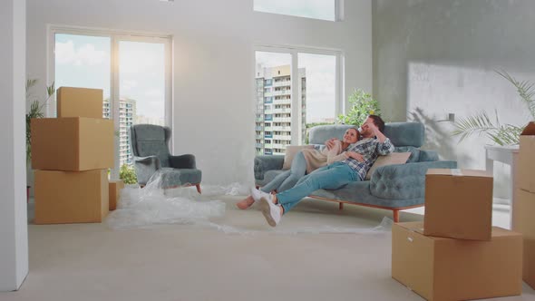 Couple relaxing on sofa alt