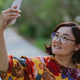Happy woman taking a selfie with her mobile phone in a blooming park - PhotoDune Item for Sale