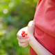 A child picking up red currant in the garden on a sunny summer day.  - PhotoDune Item for Sale