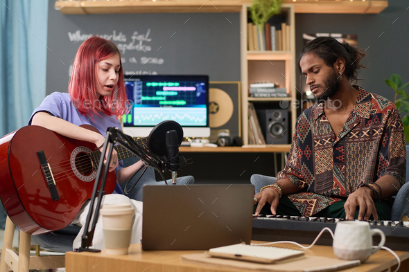 Musical duet creating new songs Stock Photo by Pressmaster | PhotoDune