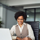 Happy young African business woman in earbuds having hybrid office meeting. - PhotoDune Item for Sale