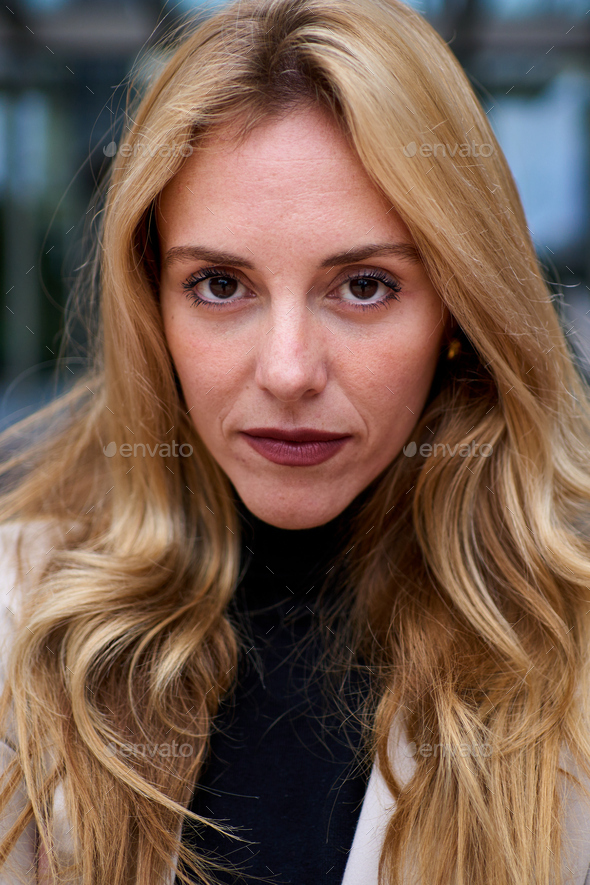 Portrait of serious and beautiful blonde business woman looking at ...