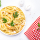 Spaghetti pasta with big shrimp, olive oil and parsley on white table background. Top view - PhotoDune Item for Sale