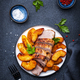 Baked pork tenderloin with spicy caramelized apples on plate, black table background, top view - PhotoDune Item for Sale