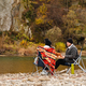happy couple having picnic at river beach - PhotoDune Item for Sale