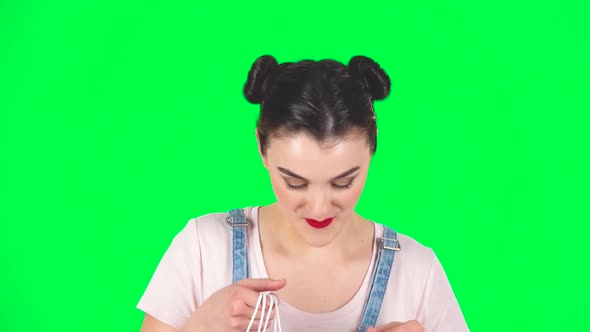 Girl Takes Out Small Box From the Packages and Is Very Happy on Green Screen, Slow Motion alt