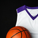 Close-Up of Basketball and White and Purple Jersey on a Black Background - PhotoDune Item for Sale
