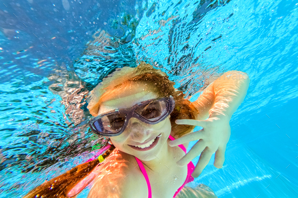 Smiling girl swimming underwater in pool Stock Photo by AFGreen | PhotoDune