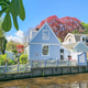 A serene blue house by the tranquil waters of a river, reflecting the sky and surrounded by lush - PhotoDune Item for Sale