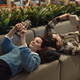 Young couple relaxing and enjoying hobbies on a cozy sofa - PhotoDune Item for Sale