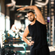 Man Standing in a Gym Holding Arm Up - PhotoDune Item for Sale
