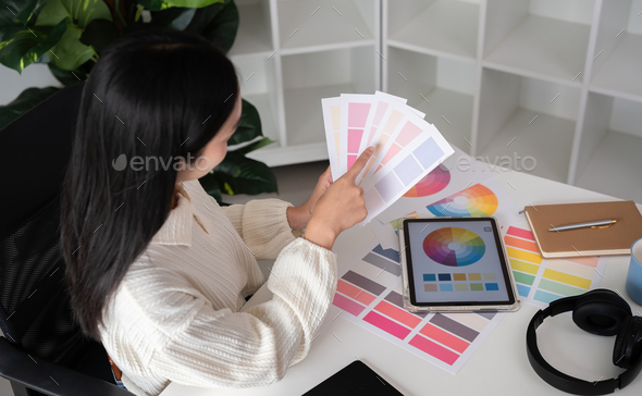 Female designer working in graphic design Choose colors for working on ...