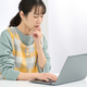 A woman wearing an apron who is worried about working on a computer - PhotoDune Item for Sale