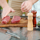 Unrecognizable man rubbing olive oil over raw beef strip steak - PhotoDune Item for Sale