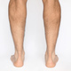 Adult male feet seen from behind observing Achilles heels and calves, with a white background - PhotoDune Item for Sale