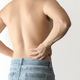 Shirtless man suffering from waist and back pain, with a white background and space for text - PhotoDune Item for Sale