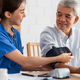 Asian caregiver doctor examine older patient use blood pressure gauge.  - PhotoDune Item for Sale