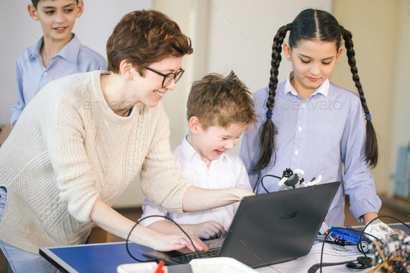 Happy children learn programming using laptops on extracurricular ...