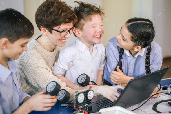 Happy children learn programming using laptops on extracurricular ...