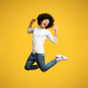 Ecstatic and amazed black guy jumping on orange background - PhotoDune Item for Sale