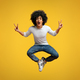 Joyful african-american man jumping up in air, demonstrating v-signs - PhotoDune Item for Sale