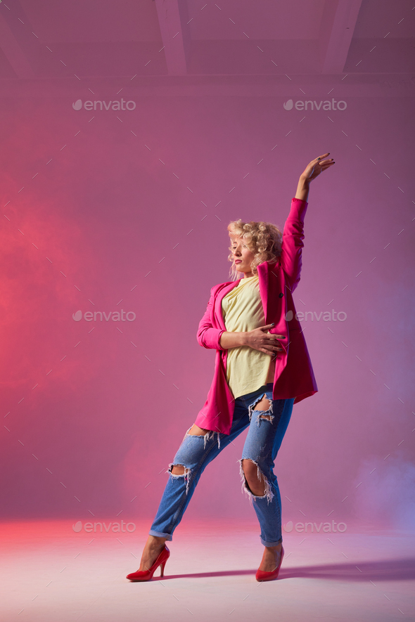 Dancer poses in front of studio background Stock Photo by Albertshakirov