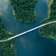 Aerial view of bridge asphalt road with cars and blue water lake and green woods - PhotoDune Item for Sale