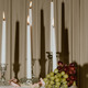 Candlesticks and lit white tapers with grapes, pearls, and pink rose petals. - PhotoDune Item for Sale