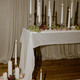 Candlesticks and lit white tapers with grapes, pearls, and pink rose petals. - PhotoDune Item for Sale