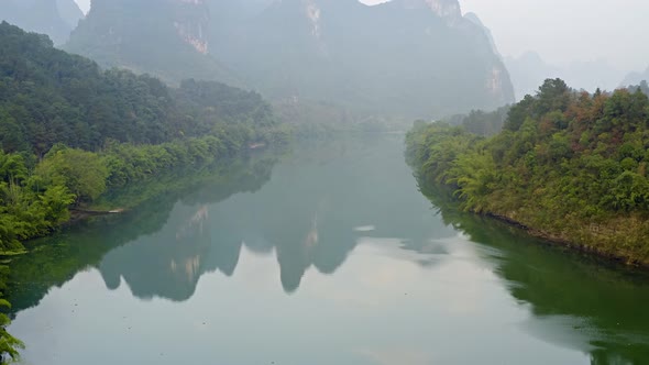 Aerial of the amazing rock formations along the Li River in China alt