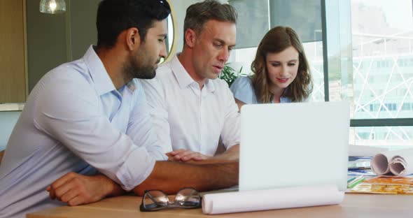 Business people working together on laptop at table in a modern office 